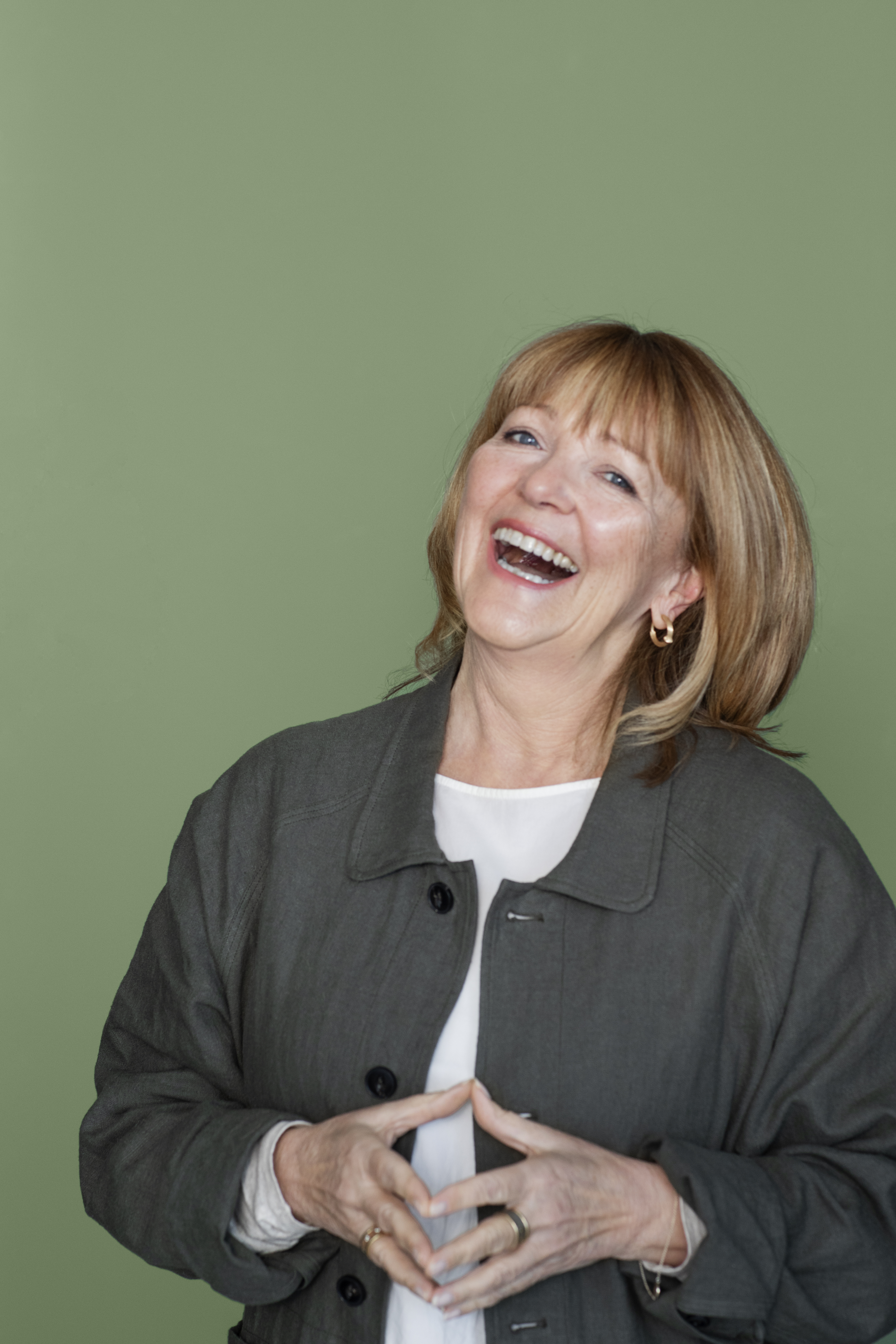 Lisbeth Larsen, Global Colour Manager at Jotun, in front of a wall painted with Jotun Lady 0125 Palmetto